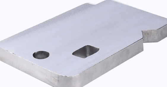 Piesă metalică cu suprafața șlefuită și finisată, înaintea rotunjirii muchiilor